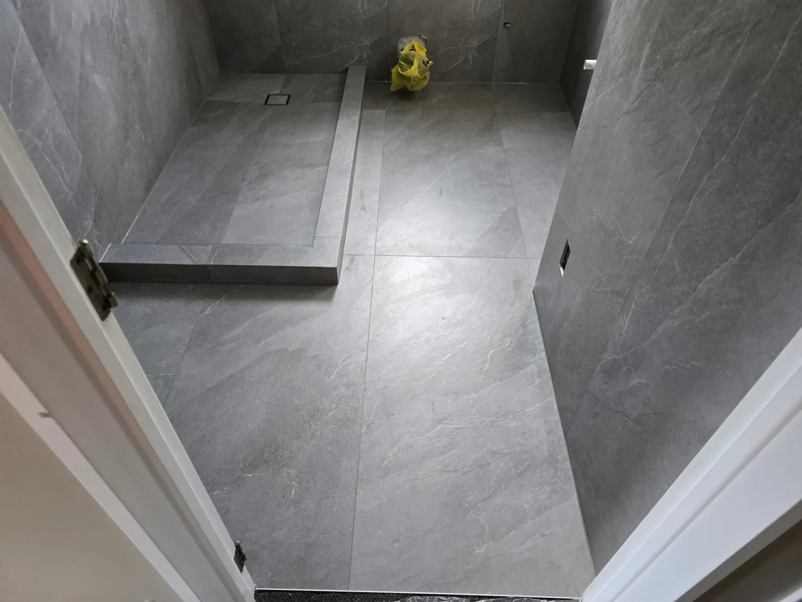 Gray slate tile bathroom with linear drain, walls and floor fully tiled