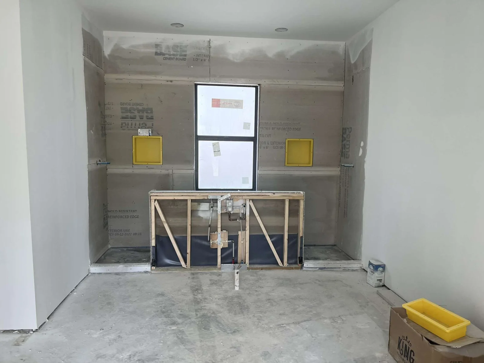 Kitchen remodel framing with drywall, electrical boxes, and window opening preparation